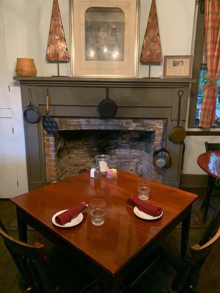 A table set for two by lamplight in the Dining House