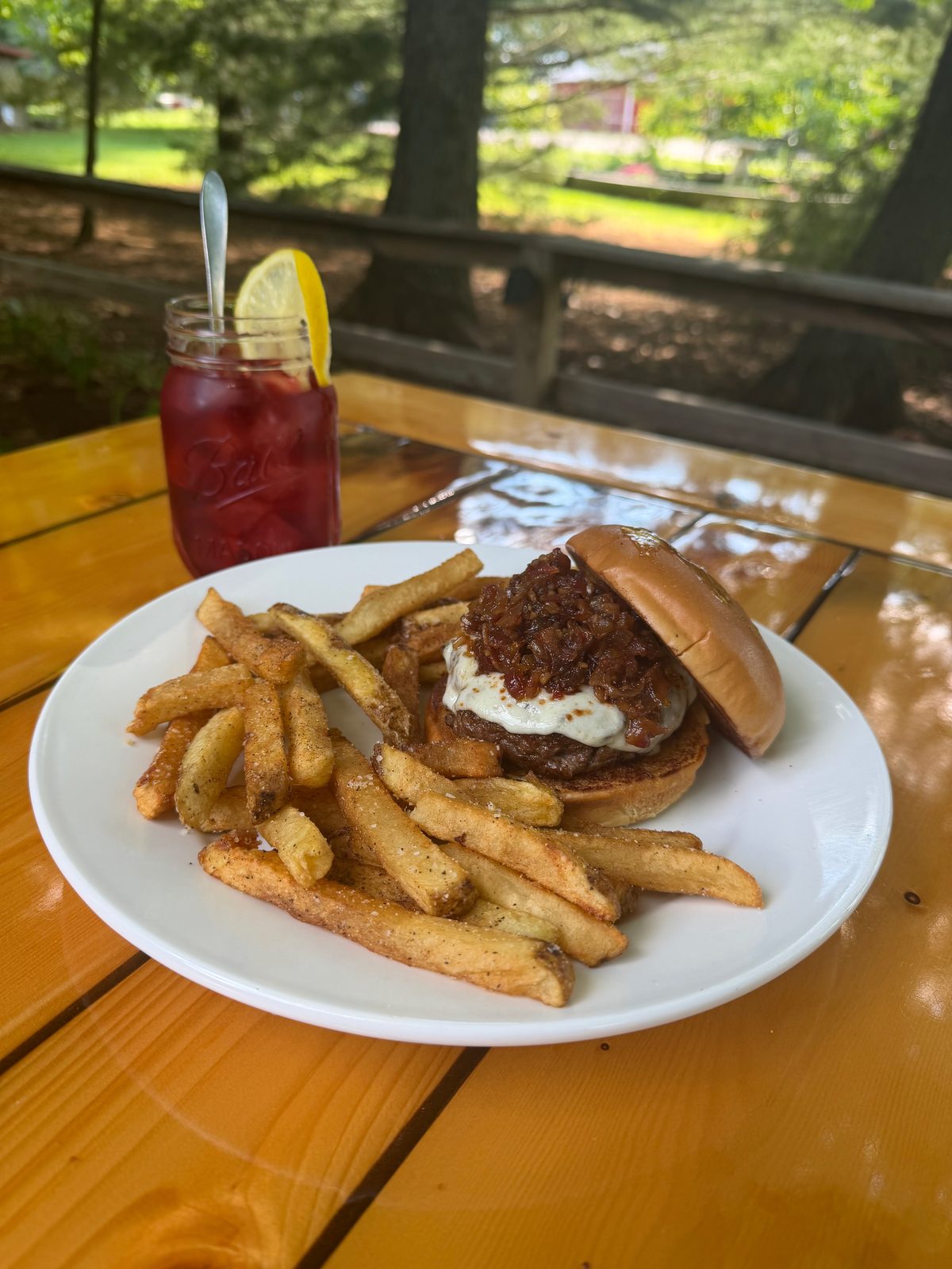 A burger made from our ribeye trimmings, with hand-cut fries, on the patio